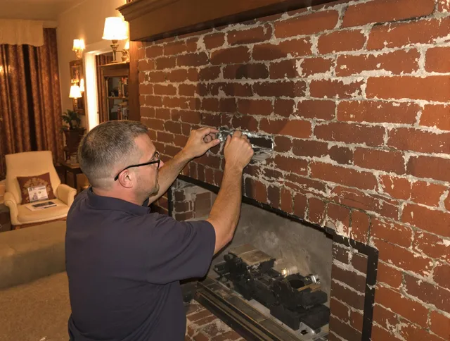 Mansfield Chimney Sweep expert fixing a fireplace in Mansfield, CT